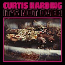 The words "It's Not Over" and "Curtis Harding" above a glossy image of Harding in a tan and flower-patterned suit lying on a carpet