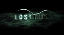 Black background with slender sans-serif words "LOST GIRL" amid curving wisps of bluish-white fog resembling long hair, and the more solid curve of a female form laying on its side.