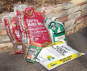 Plastic bags of gardening supplies fresh produ...