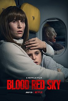 "Official release poster": On board a plane, a woman hugs her child. A reflection of her in the window shows a monster.