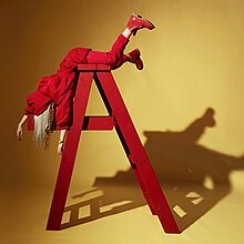 Eilish is seen posing on a ladder