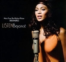 A woman is standing against a dark background. She wears a blouse and a headband while she sings with a microphone she has in front of her. The words "Music from the Motion Picture", "Dreamgirls", "Listen" and "Beyoncé" are written next to her image.