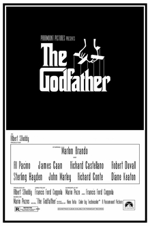 "The Godfather" written on a black background in stylized white lettering, above it a hand holds puppet strings.
