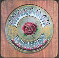 A woodgrain panel with a circle in the middle—inscribed is a rose surrounded by the words "American Beauty".