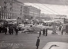 Вертолёт Ка-27 майора Ольховика лежит на площади Восстания. Отчётливо видно повреждённый трамвай и работу аварийных служб.