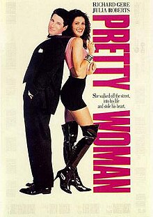 A man in a suit stands back to back with a woman wearing in a short skirt and thigh high boots.