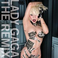 A young blond woman stands naked with her right hand above her head and wearing a black glove on her left hand. Parts of her body, like her breasts and stomach are covered with thin stripes of newspaper. Behind her, a panorama of buildings can be seen. To her right, the words "Lady Gaga" and "The Remix" are written in white capital font and slanted from top to bottom.