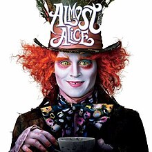 The mad hatter staring directly at the viewer holding up a cup of tea.