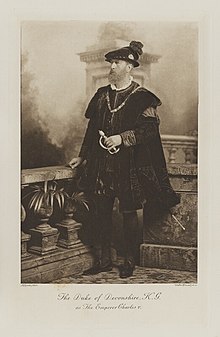 Black-and-white photograph of a standing man in a historical costume