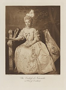 Black-and-white photograph of a seated woman in a historical costume