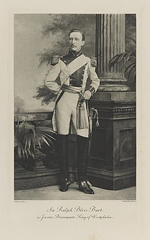 Black-and-white photograph of a standing man in an historical military with over-the-knee boots, epaulettes and a sword