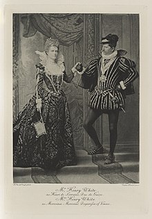 Black-and-white photograph of a man and woman richly dressed in a historical costume
