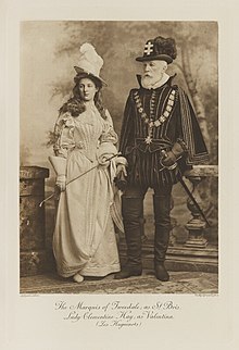 Black-and-white photograph of a young woman and her father richly dressed in an historical costume