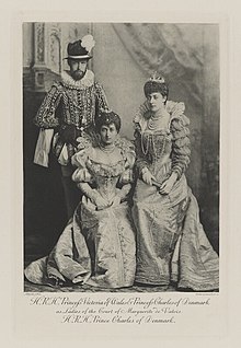 Black-and-white photograph of a man and two women in historical costumes