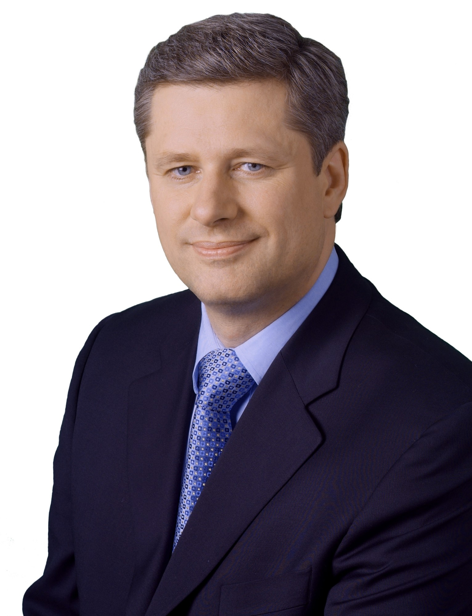 Canadian Prime Minister Stephen Harper autographs a fan's jersey