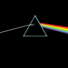 Original album artwork featuring an almost black cover with a triangular prism in the middle. A ray of white light enters the prism from the left and is refracted into colours as it comes out the right side.