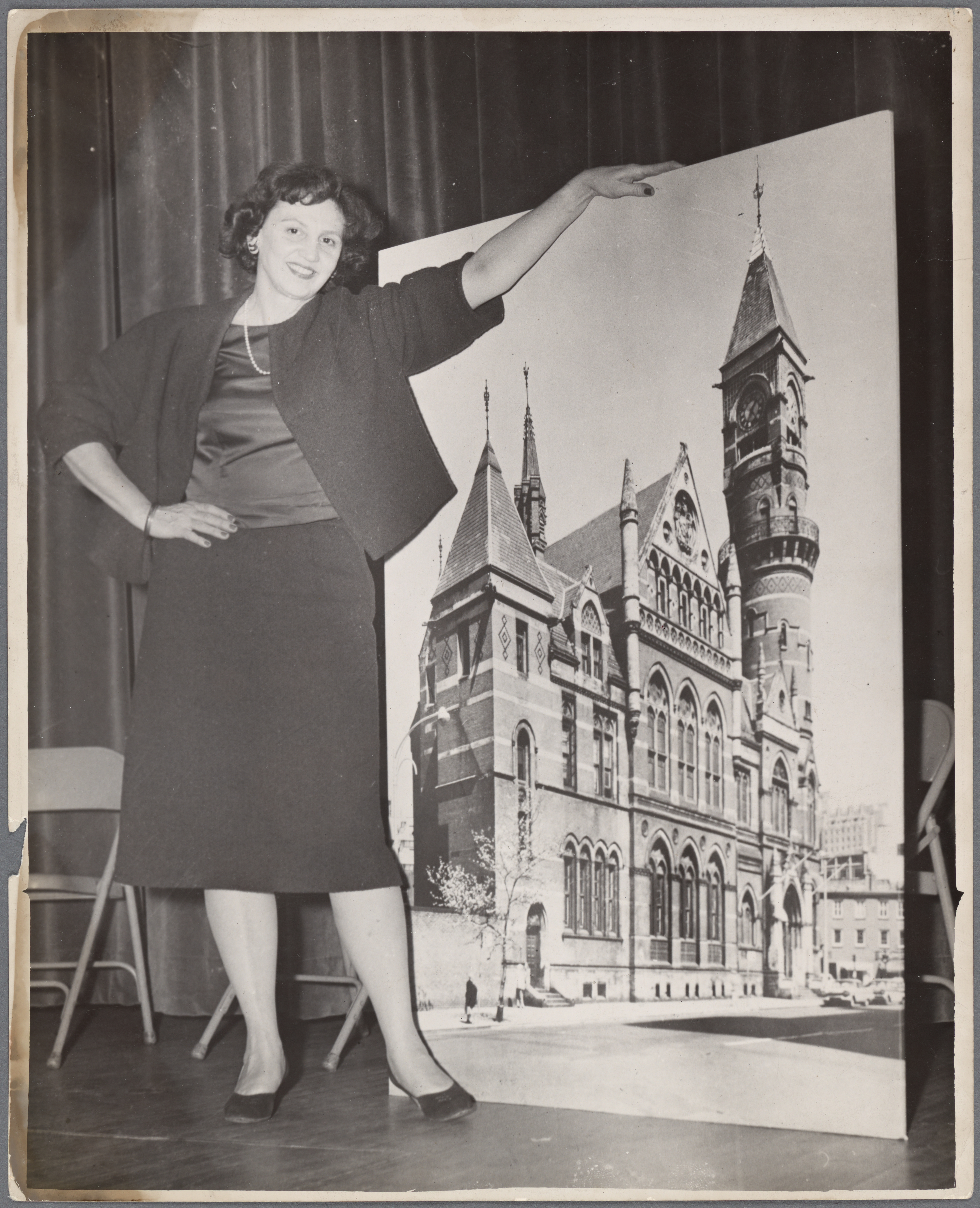 Margot Gayle with an enlarged photograph of the Jefferson Market Courthouse building.