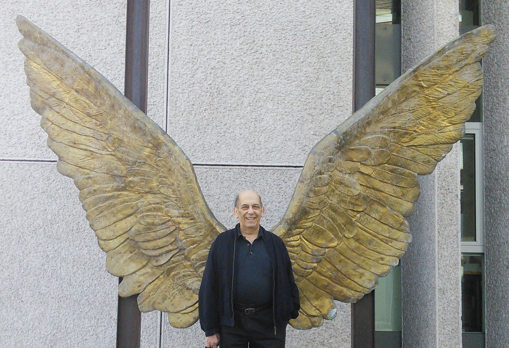 Stan Persky in front of the 'Wings of Mexico' by [[Jorge Marín]] at the Embassy of Mexico, Rauchstraße 27, Berlin-Tiergarten