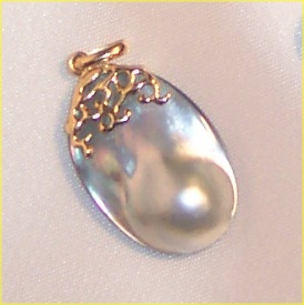 A blister pearl, a half-sphere, formed flush against the shell of the pearl oyster.