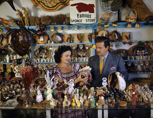 File:John M. Gonatos in his curio shop viewing shells with assistant Niki Vasilikis in Tarpon Springs, Florida.jpg