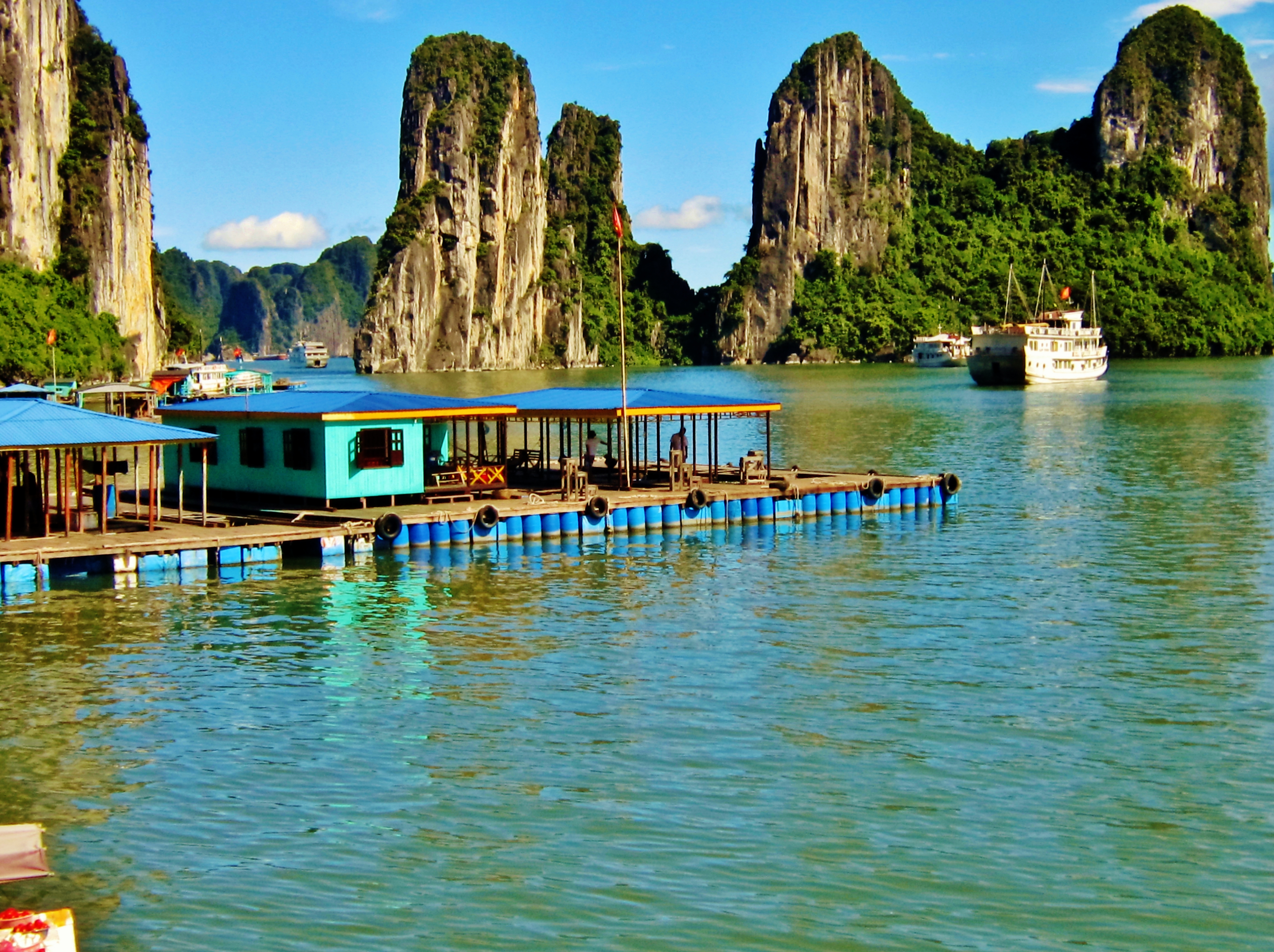 Floating fishing village on the water with fish farm and nets in Halong Bay  in Vietnam - a Royalty Free Stock Photo from Photocase