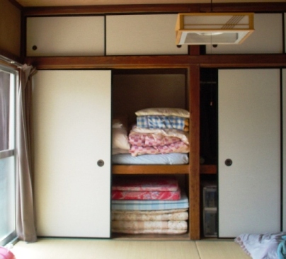 Futons stored in an oshiire, in a tatami-floored washitsu (traditional Japanese room)
