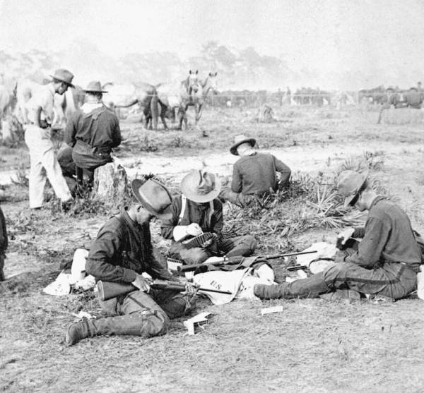 File:Rough Riders filling belts with cartridges (3464894339).jpg