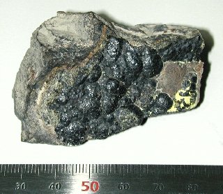 This sample of uraninite contains about 100,000 atoms (3.3×10−20 g) of francium-223 at any given time.[61]