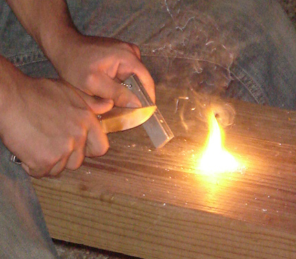 Magnesium firestarter (in left hand), used with a pocket knife and flint to create sparks that ignite the shavings