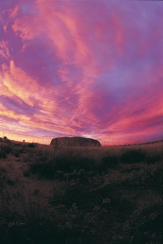 Uluru at sunset By Toursim NT [Attribution], via Wikimedia Commons