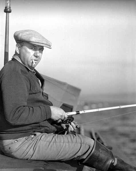 File:Fisherman smoking and holding and a fishing rod, probably