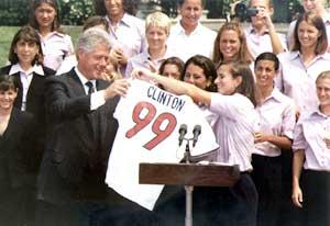 President Bill Clinton congratulates the 1999 FIFA Women's World Cup-winning United States women's national soccer team on the White House South Lawn and receives a #99 jersey, July 1999. Bill Clinton with 1999 USWNT.jpg