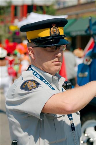 An RCMP officer wearing the operational uniform without a bulletproof vest.