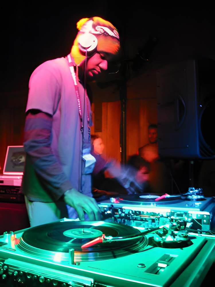 A DJ mixing vinyl records with a DJ mixer at the Sundance Film Festival in 2003