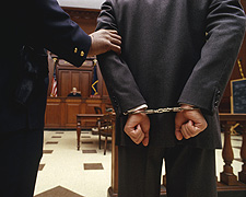 Cuffed defendant before criminal court (Transportation Security Administration image)