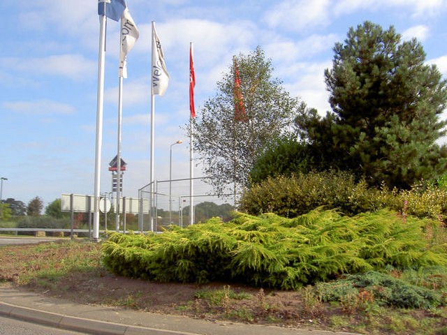 File:Flags on roundabout into designer outlet car park. - geograph.org.uk - 546115.jpg