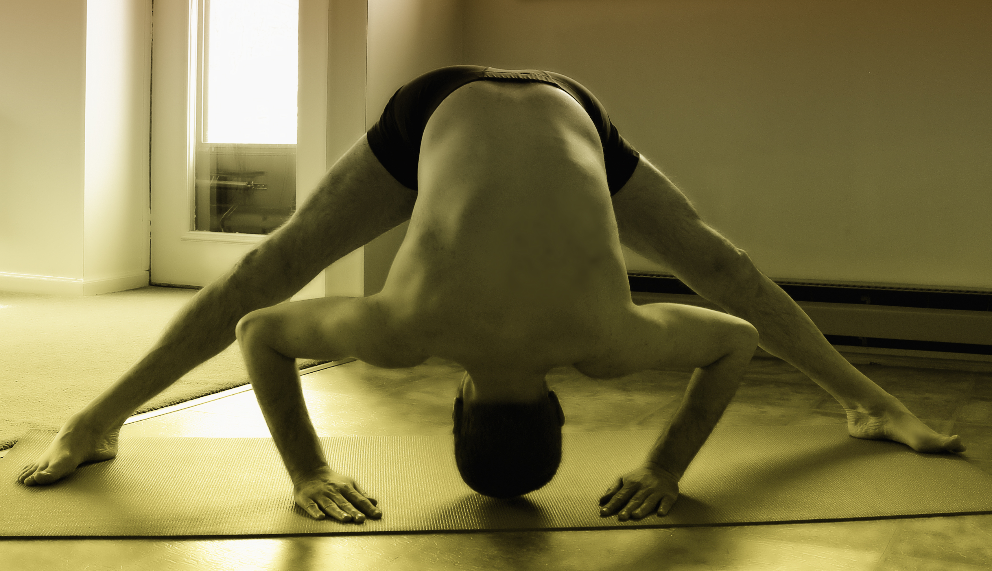 Yoga Pose: Revolved Wide Legged Forward Bend