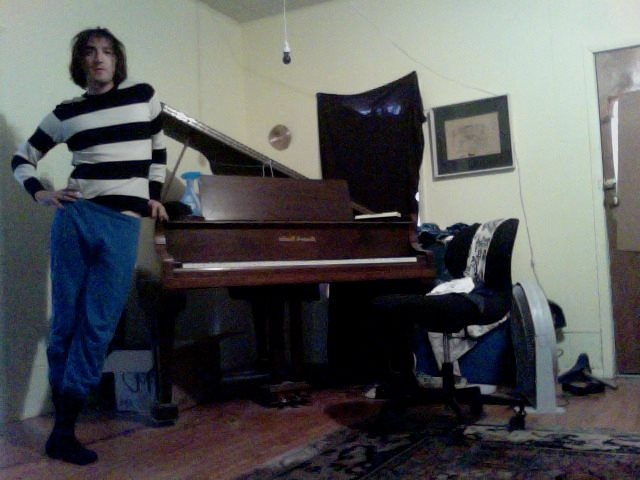 File:David loca part time next to his piano.jpg