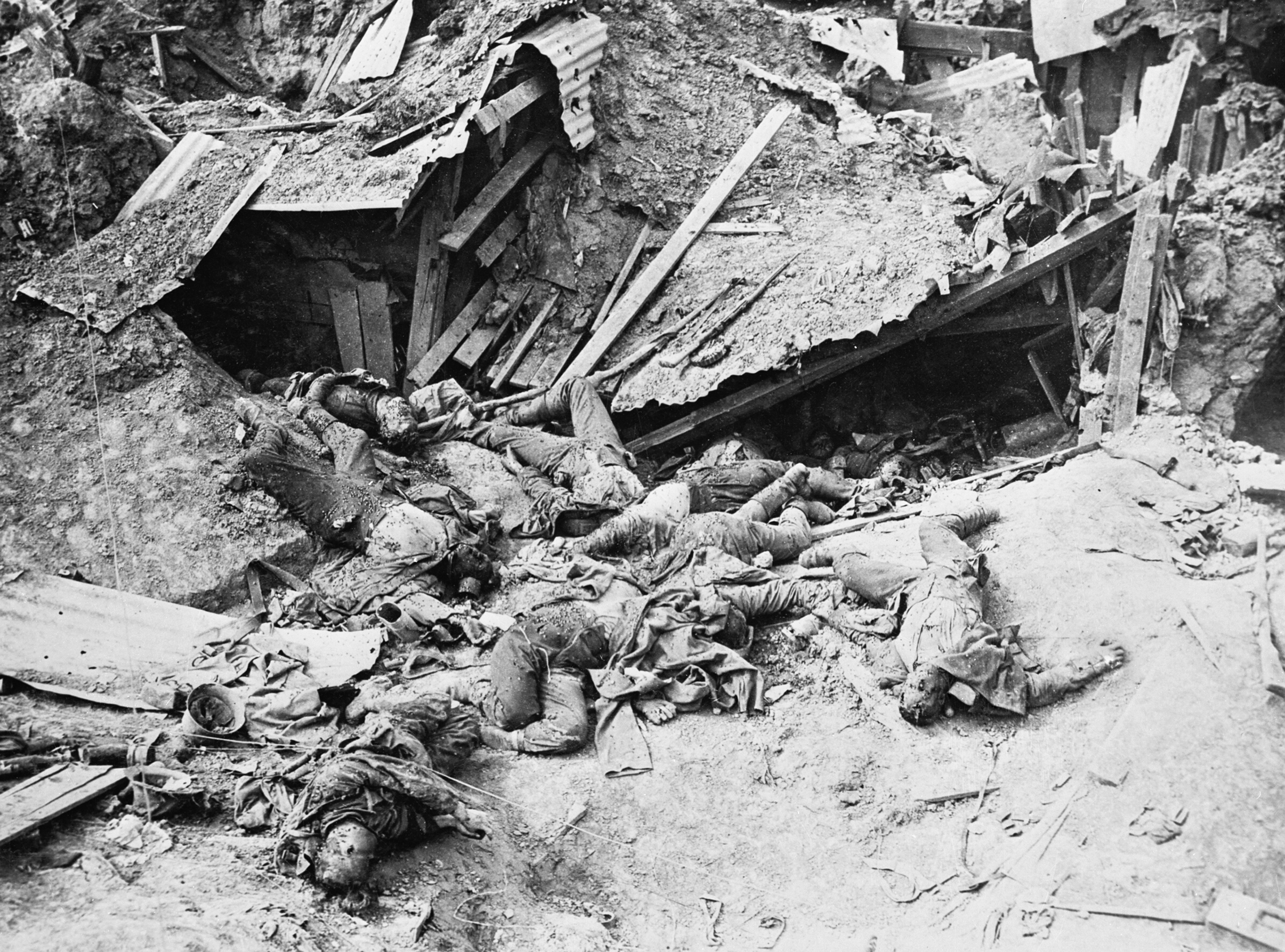 "The Battle of Guillemont. 3 -5 September 1916. Dead German soldiers scattered in the wreck of a machine gun post near Guillemont. The photograph shows the destruction which occurred when the defence had no deep shelter." Taken by John Warwick Brooke.