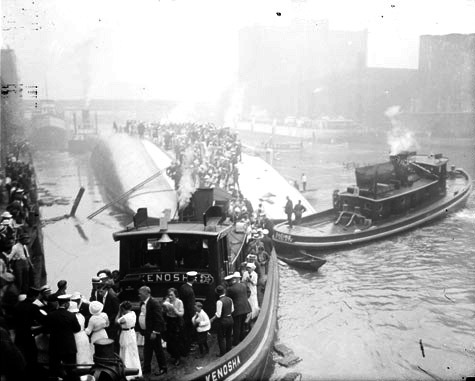 Eastland disaster, the Kenosha, a tugboat, rescuing survivors from the hull of the overturned steamer. Chicago Daily News, Inc., photographer.