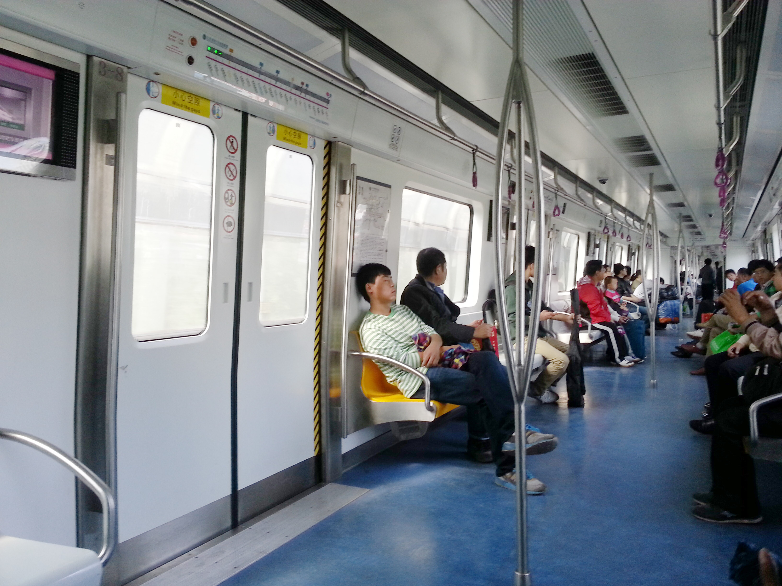 Students play online games inside a subway train in Beijing