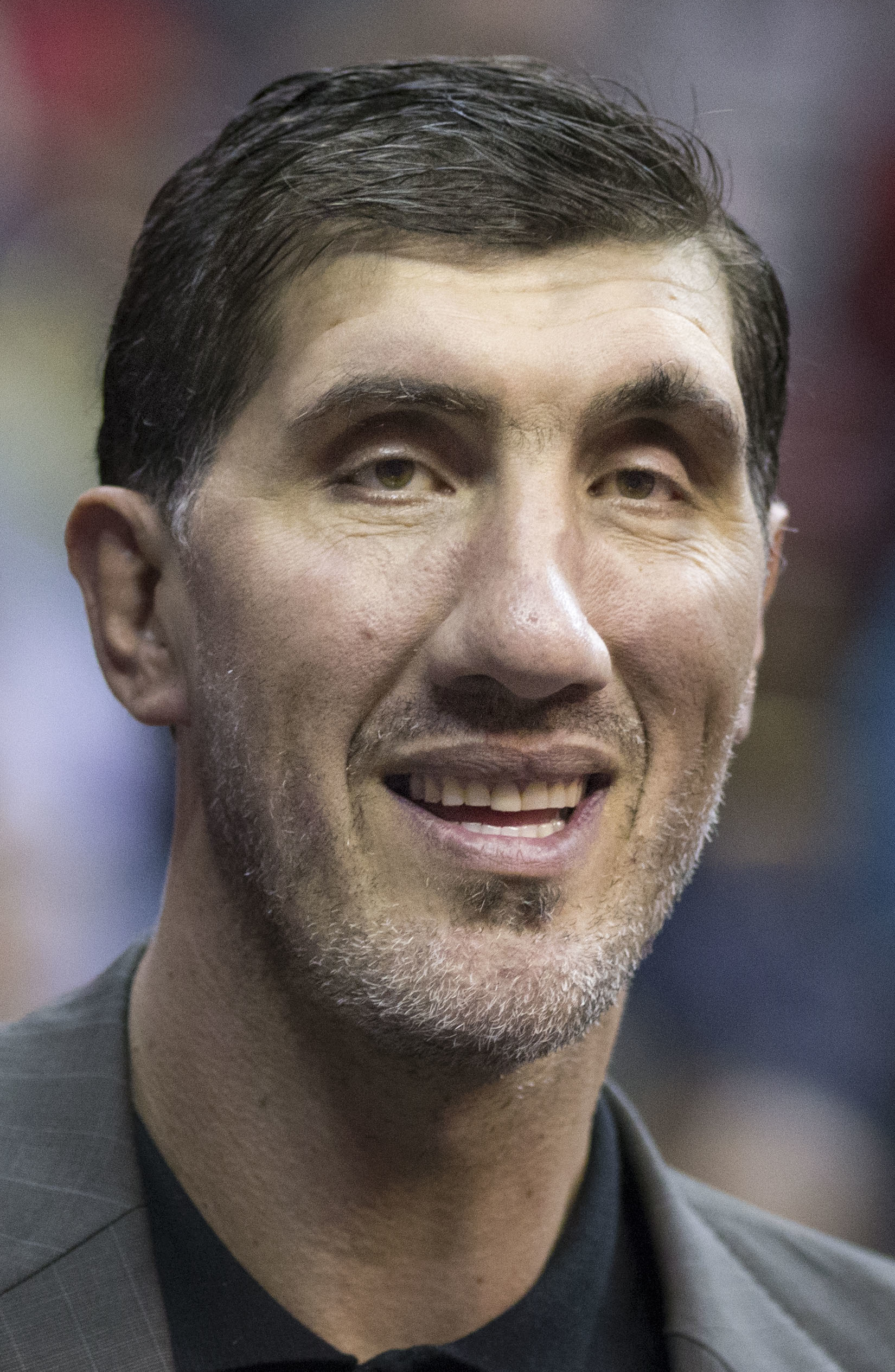 Former NBA player Gheorghe Muresan tosses a basketball to a child
