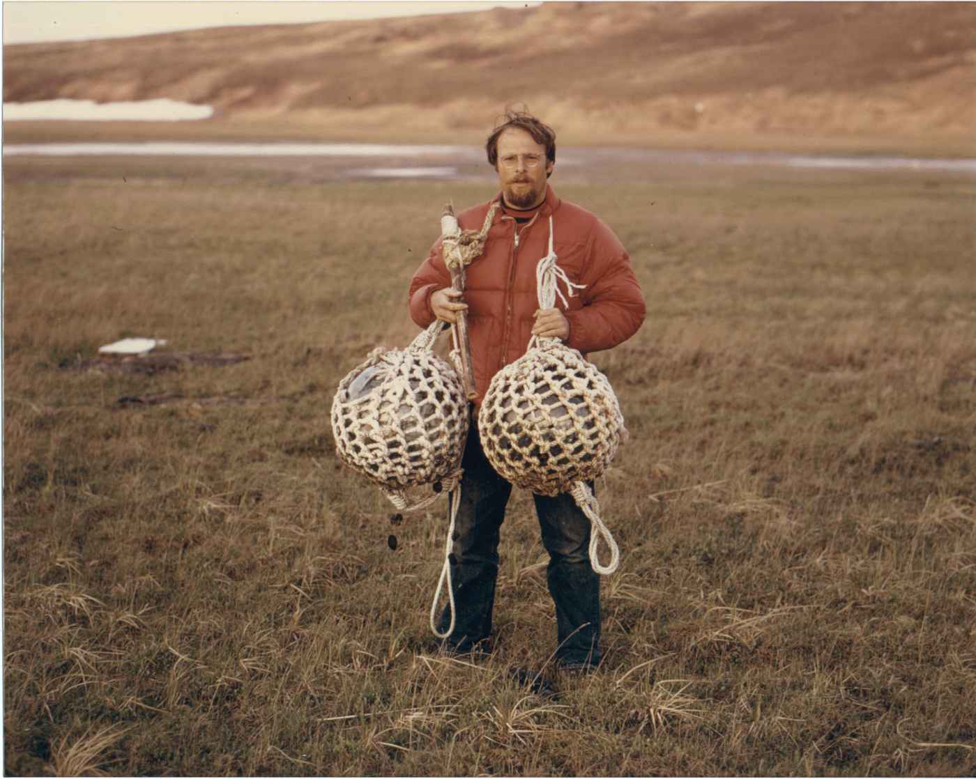 File:Man holding two large glass japanese fishing floats.jpg