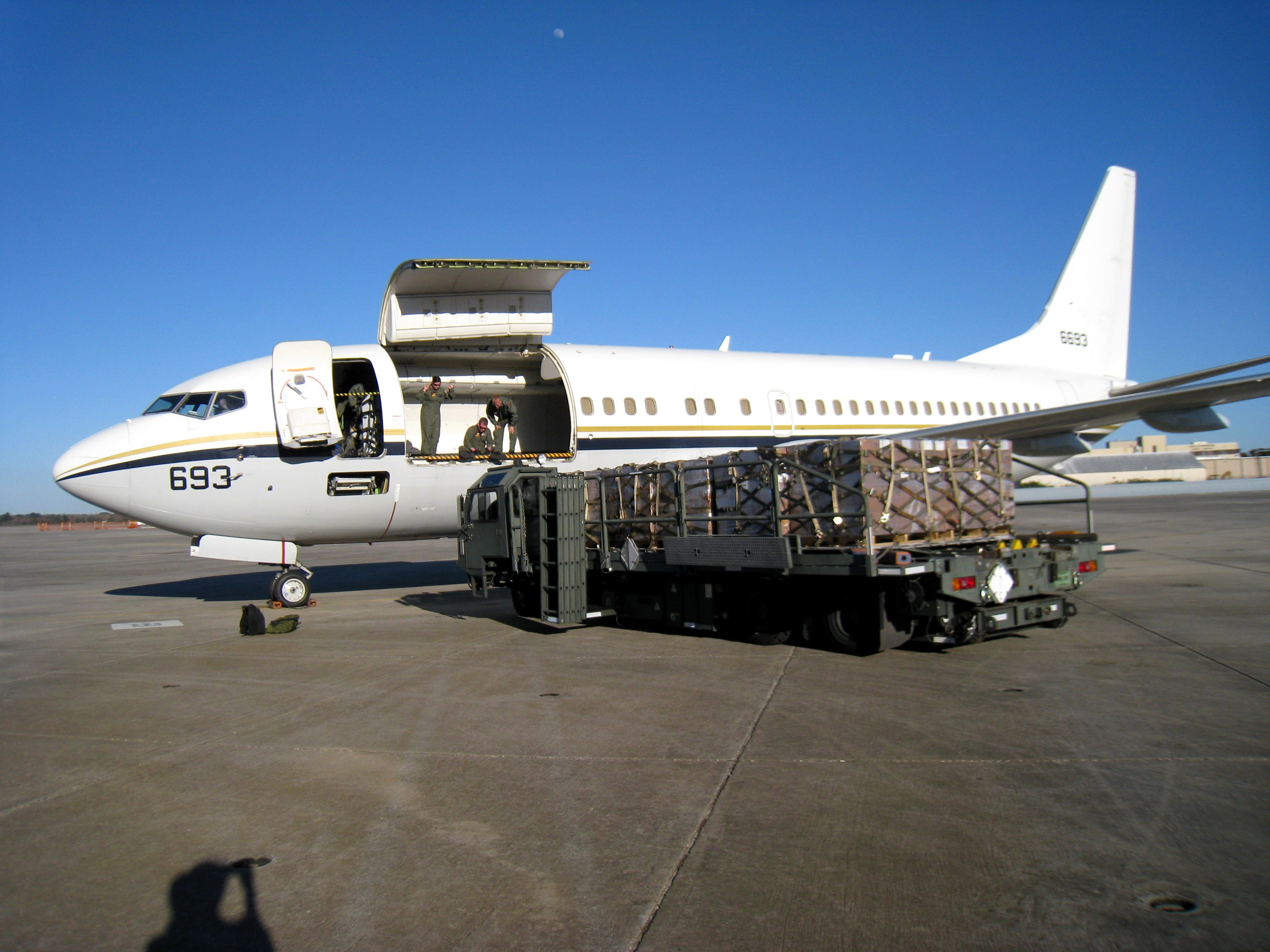 US_Navy_100126-N-0705K-003_Naval_Air_Crewmen_2nd_Class_Nicole_Garza_and_David_Murray_and_Naval_Air_Crewman_1st_Class_David_McDermott_load_cargo_bound_for_Haiti_at_Naval_Air_Station_Jacksonville.jpg