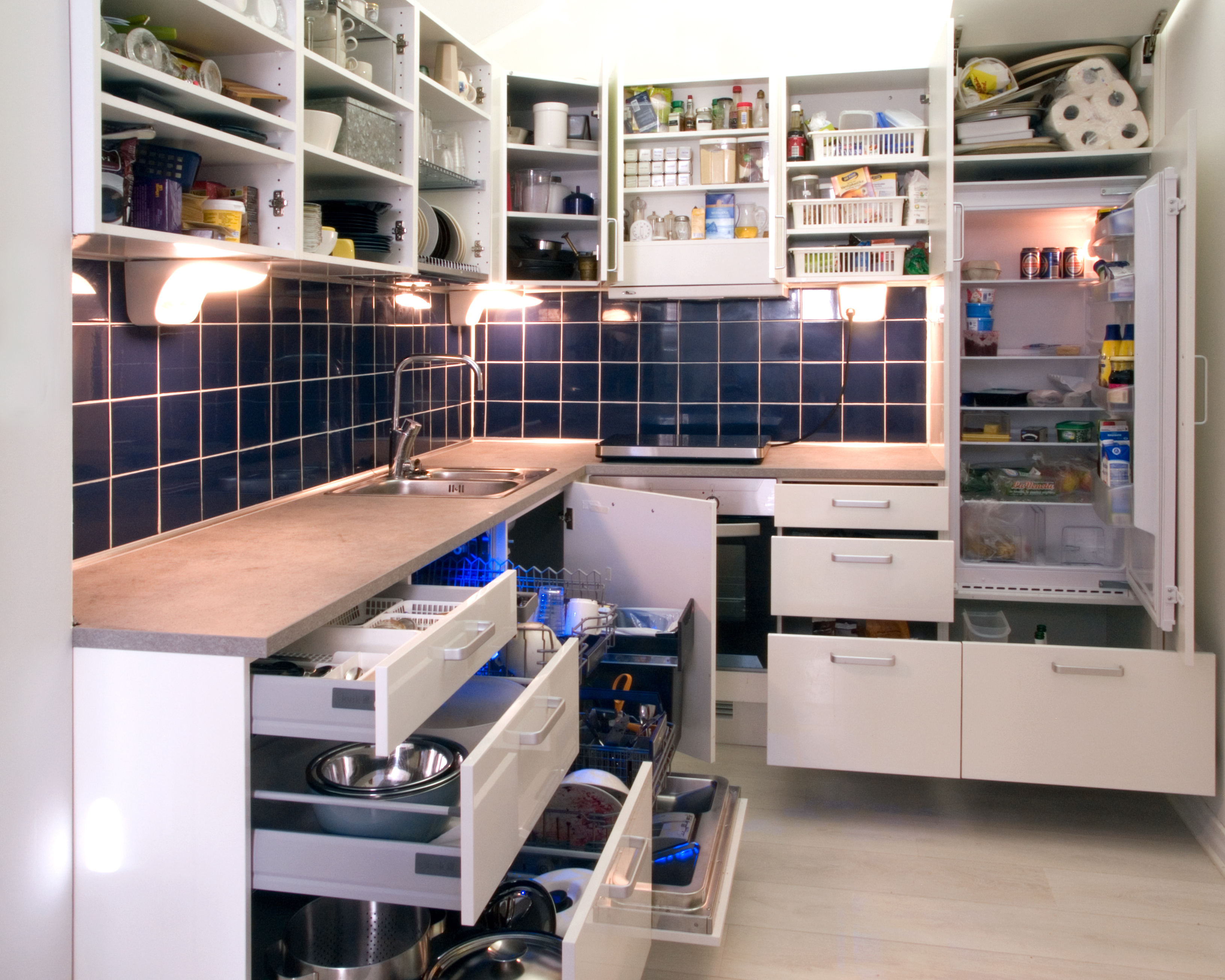File:White kitchen with cabinet doors and drawers opened or removed so that  real-life stuff can be seen in cabinets.jpg - Wikimedia Commons