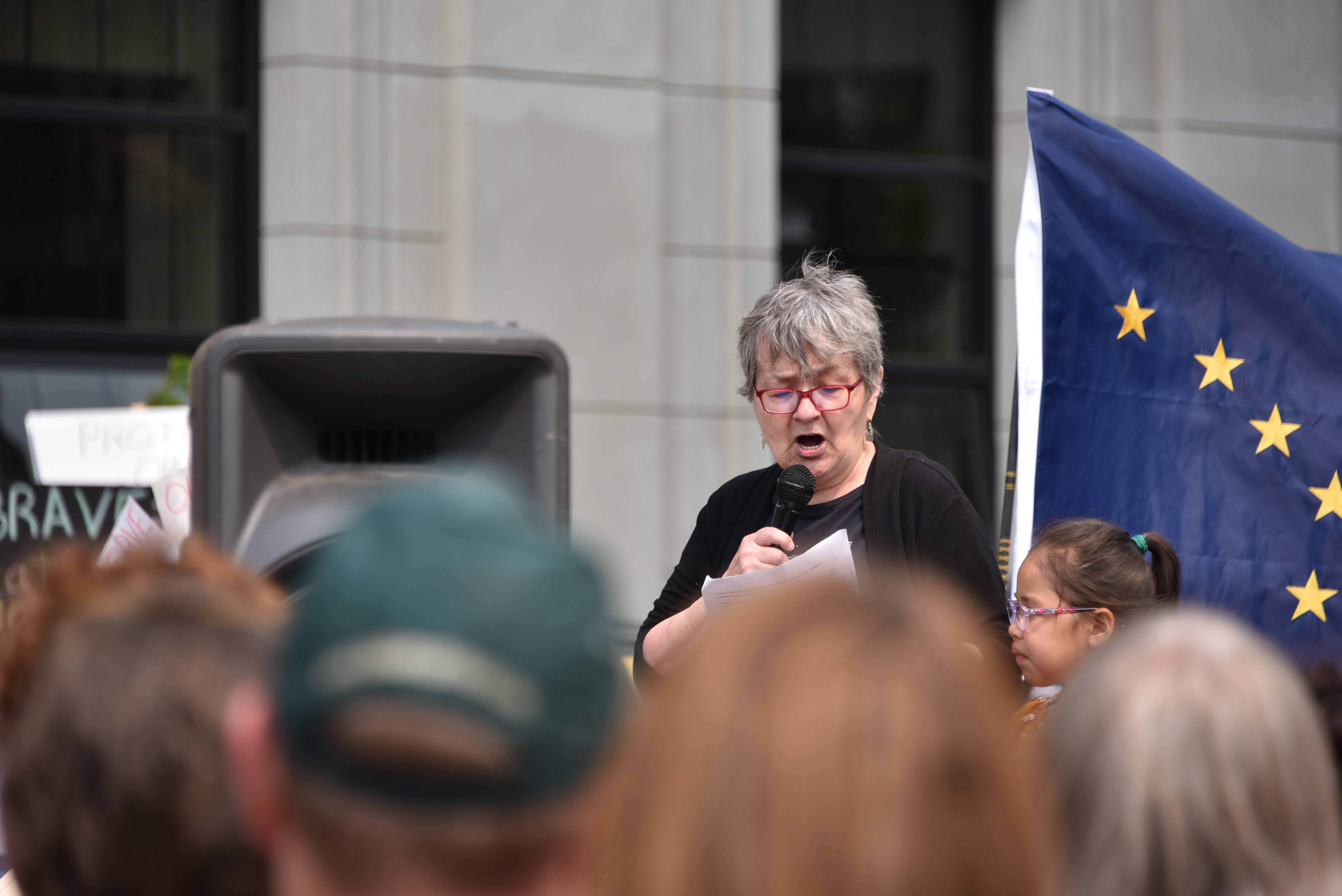 Ernestine Hayes speaking in front of the [[Alaska State Capitol]] in July 2019