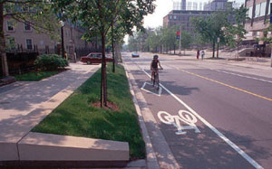 A person rides a bicycle in a bike lane in Toronto.
