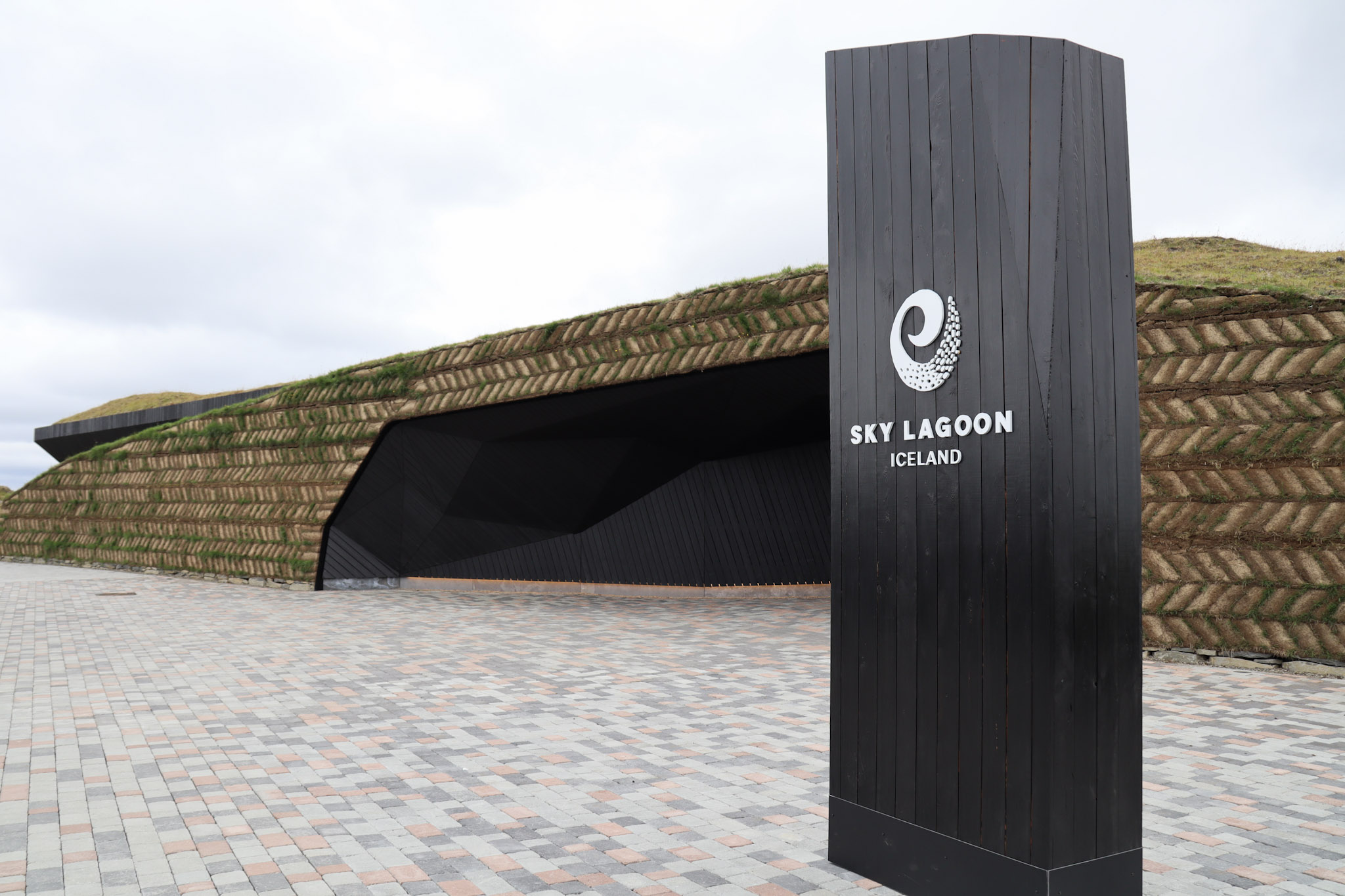 Exterior of Sky Lagoon with sign and turf wall