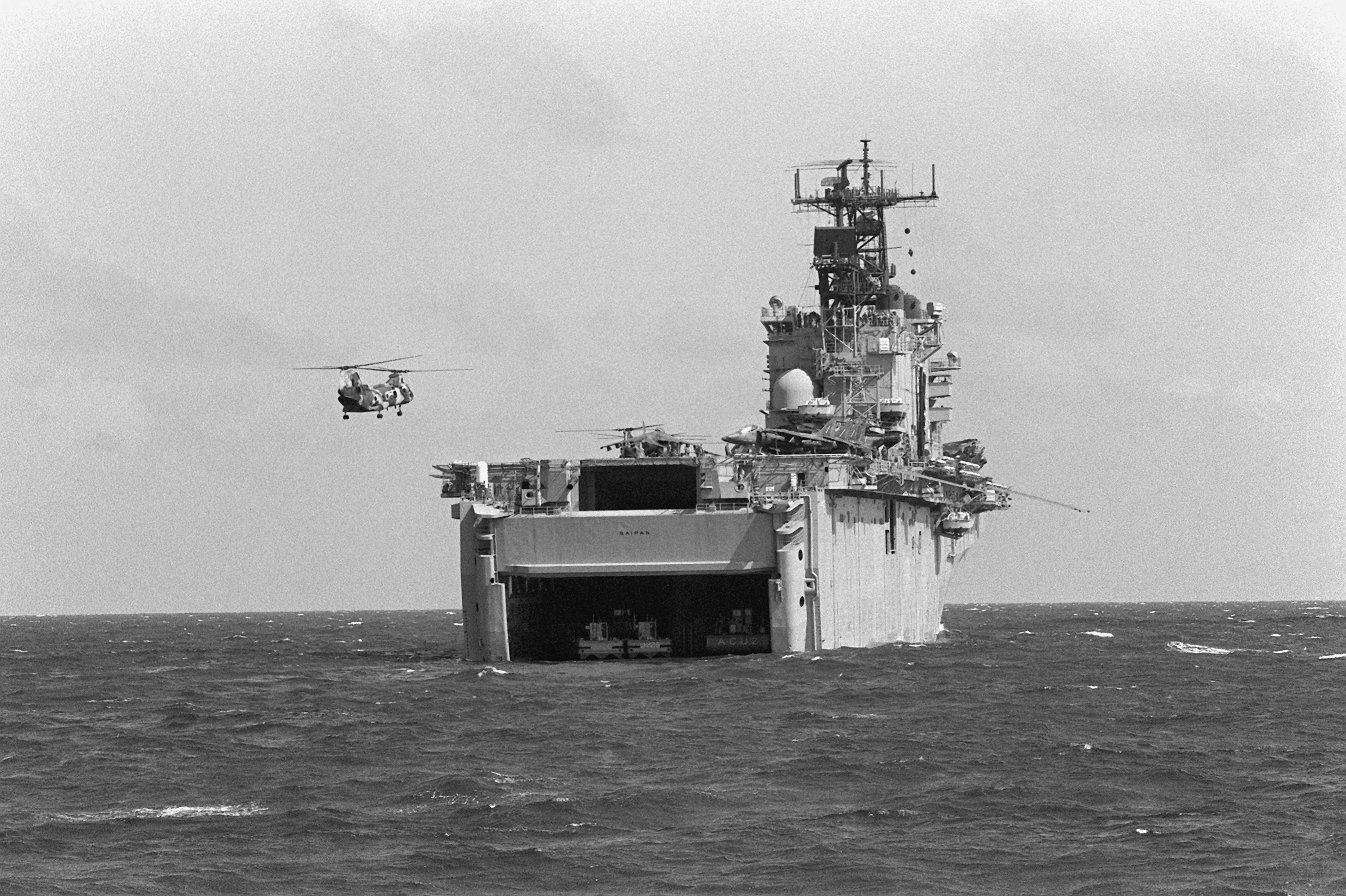 A CH-46E Sea Knight helicopter approaches amphibious dock landing