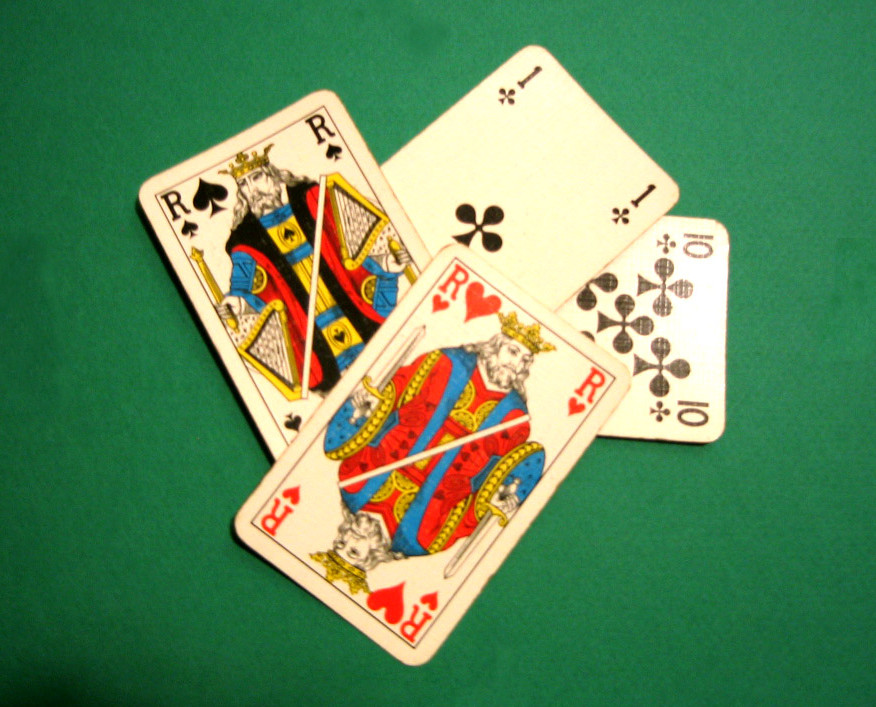 A set of three playing cards showing a Jack, Queen and King. All